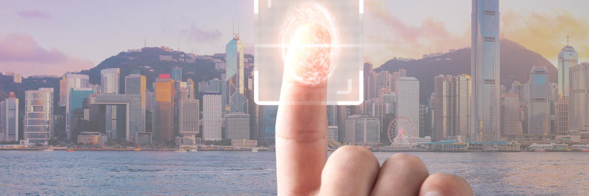 Finger scanning a digital fingerprint with the Hong Kong skyline in the background, symbolizing the integration of technology and business identification through the Unique Business Identifier (UBI).