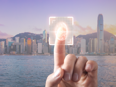 Finger scanning a digital fingerprint with the Hong Kong skyline in the background, symbolizing the integration of technology and business identification through the Unique Business Identifier (UBI).