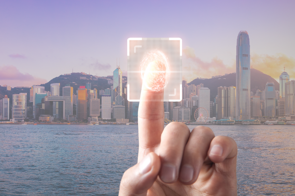 Finger scanning a digital fingerprint with the Hong Kong skyline in the background, symbolizing the integration of technology and business identification through the Unique Business Identifier (UBI).