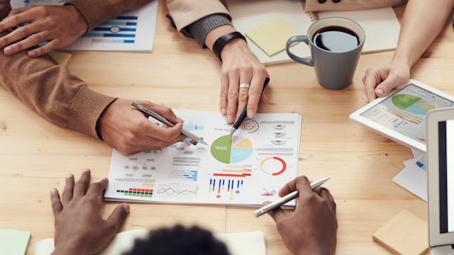 A group of people discussing statistics